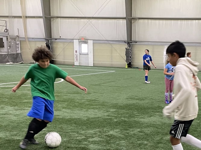 Photo of boys kicking soccer ball