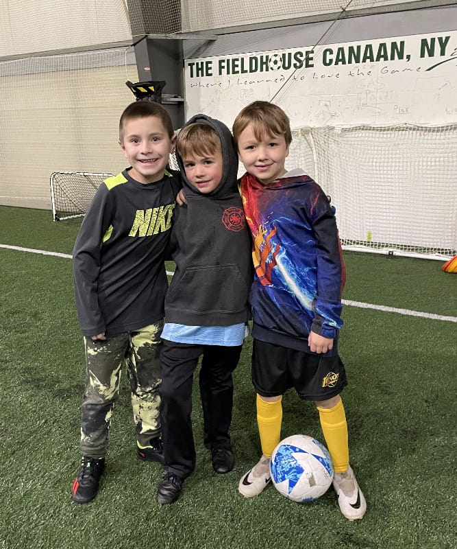 Photo of three soccer friends